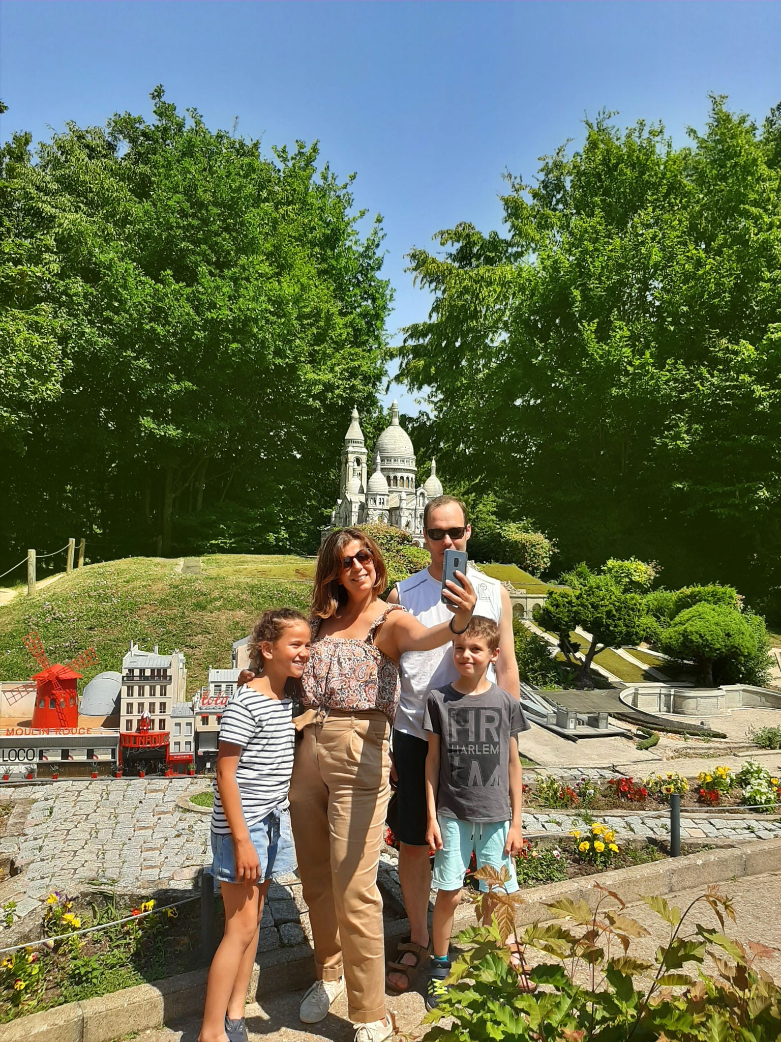  Family taking selfie in front of paris Sacré-Coeur at France Miniature