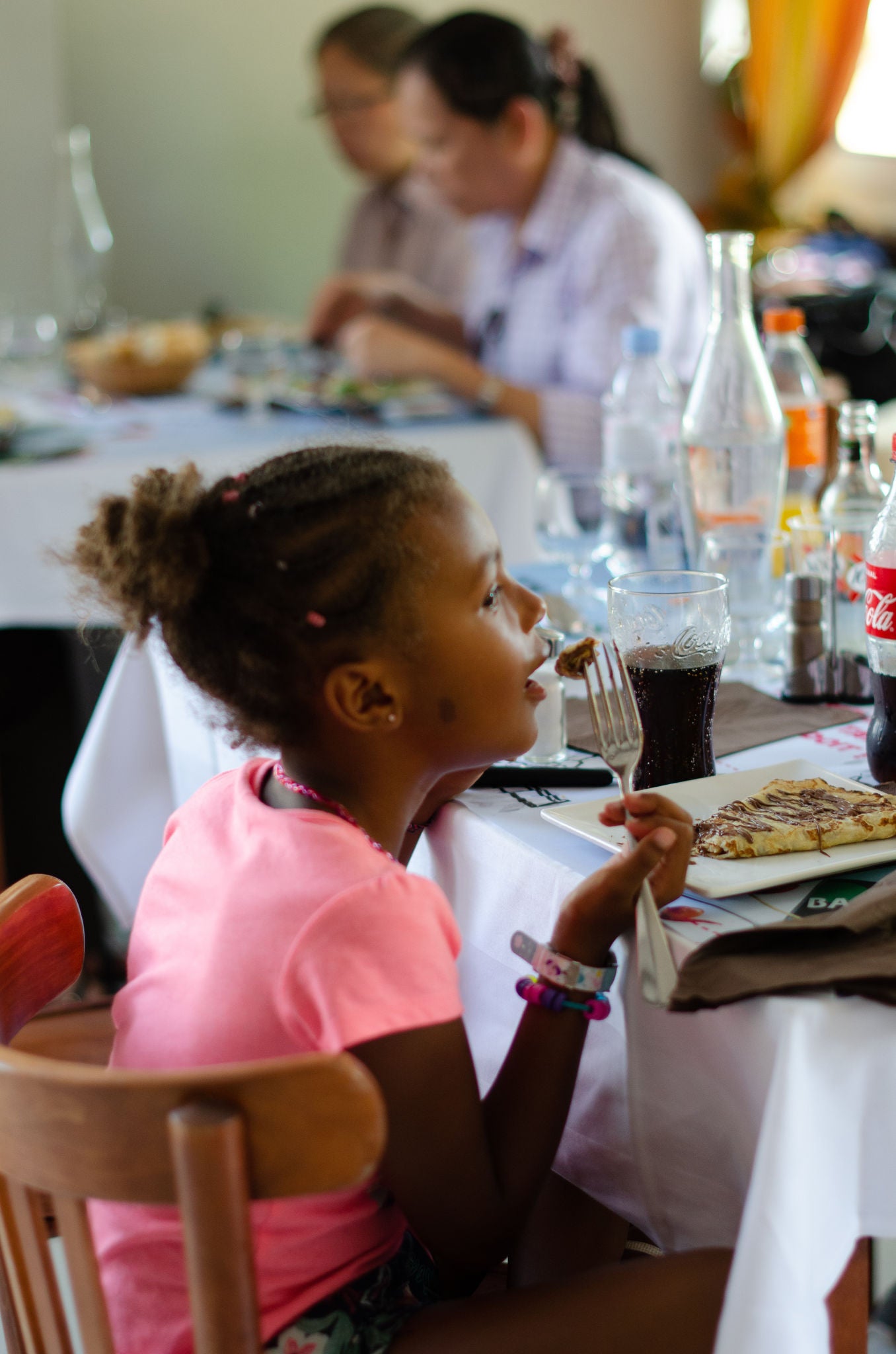 Little girl enoying her crepes at the Restaurant "Les Provinces" in France Miniature