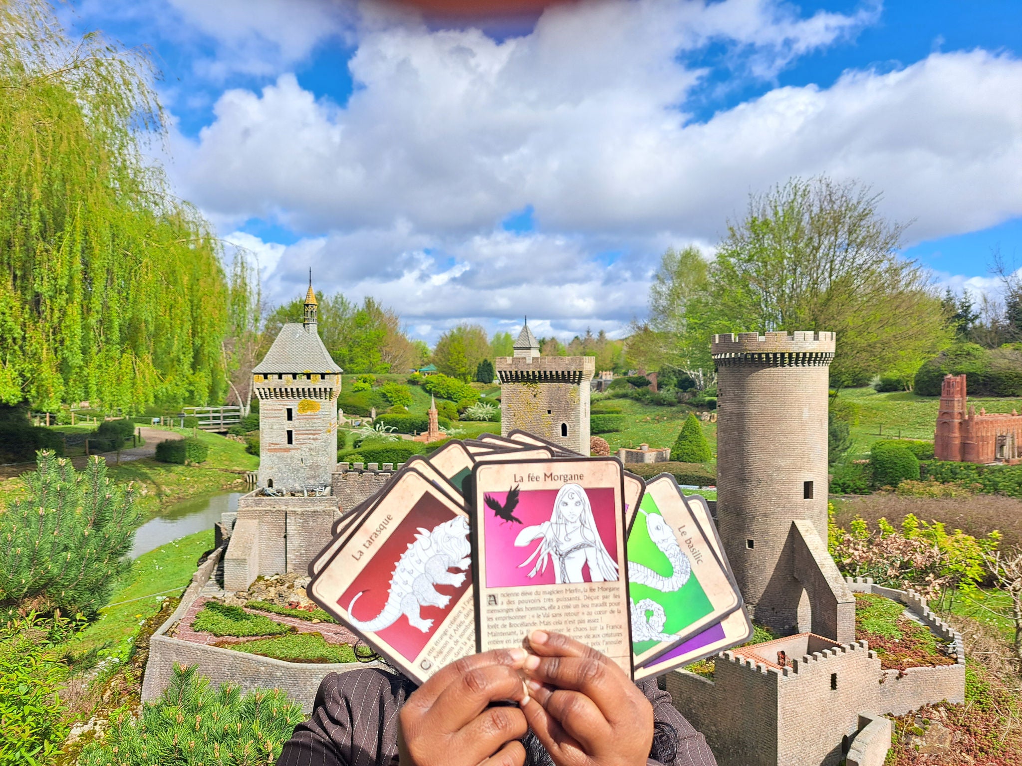 Display of cards from France des légendes in front of chateau de foix at France Miniature