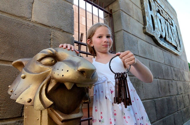 Girl with keys in front of Fort boyard at France Miniature 